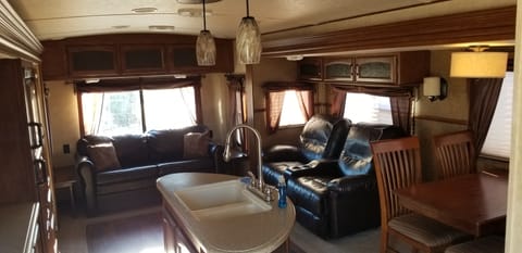 Rear lounge. Rear sofa sleeps 2. 2 hug the wall recliners, recliner also a sleeper and very comfortable. 4 dining chairs with table.
