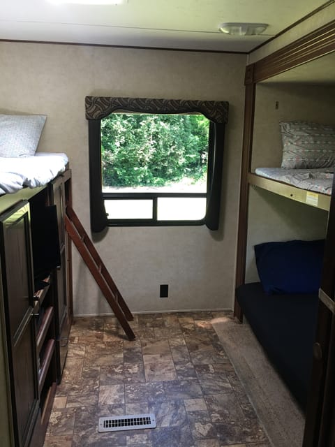 3 bunks and a trundle bed, separated back bedroom, built in storage and tv/dvd player. 