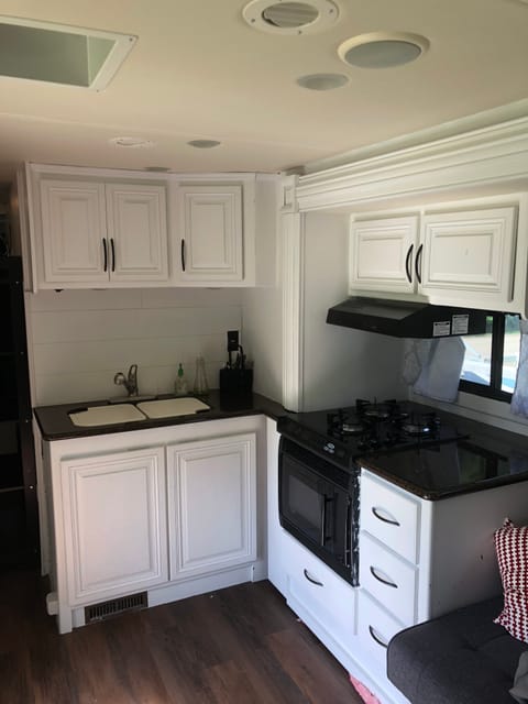 Kitchen with microwave/convection oven, and gas stove.  