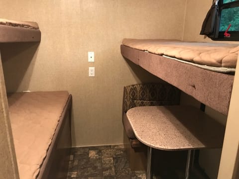 Two single bunks on top, double on the bottom. The dinette also can turn into a single bed or an arm wrestling table, depending on where the night takes you.