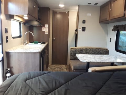 Facing from the front to the back of the trailer.  Table converts to a short double bed.