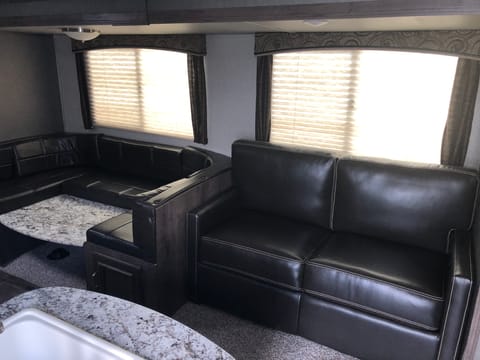 Leather couch and dinette which convert to beds