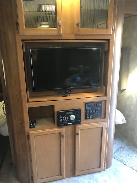 TV with DVD player, ove rthe air antenna/ bluetooth capabilities, am/fm radio/AUX/ connects with speakers throughout unit including outside speakers.