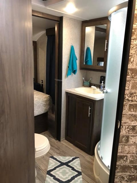 Bathroom has plenty of space and a walk-in shower