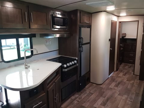 Spacious Kitchen with Bathroom door on left & private bunk room at back