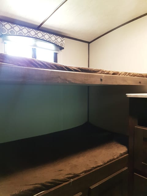 Twin over twin bunks with storage below bottom bunk in private bunk room