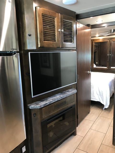 Residential refrigerator, 45 HD TV and fireplace.