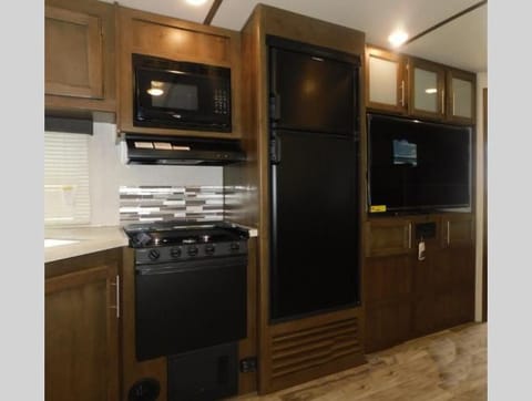 Kitchen with refrigerator, stove, sink microwave