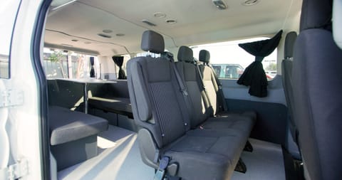 The interior of the van with the seating area set up. 