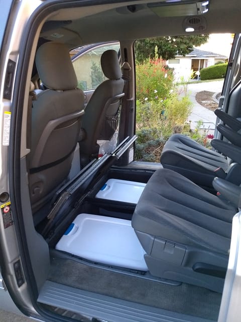 Middle seats ready, with storage boxes showing in the compartments the seats alternatively fit in.