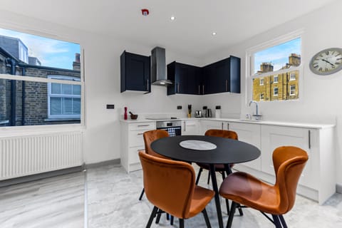 Burnt Orange & Bay Windows Apartment in London