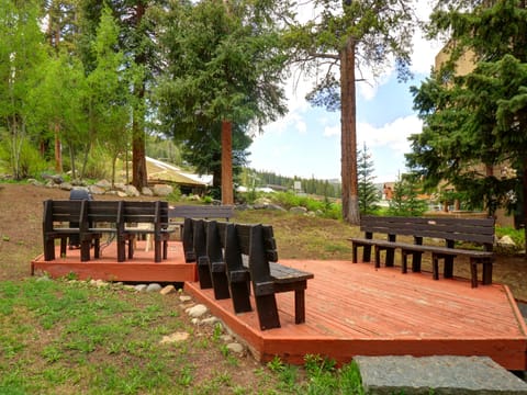 Deck area with bench seating and grill.