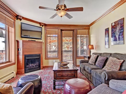 Looking over to the fireplace and TV, with access to the private balcony to the right.