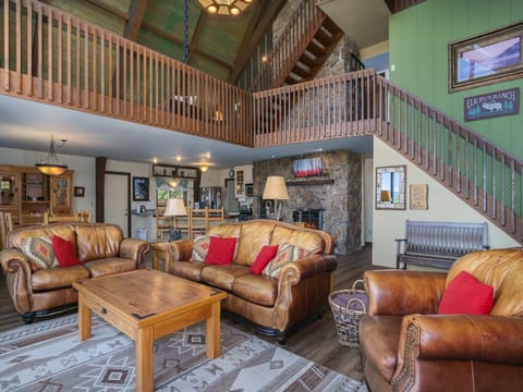 Sky View in the Rockies - Living Room with a sofa, loveseat, overstuffed couch and a loft above 14 stairs to each loft area