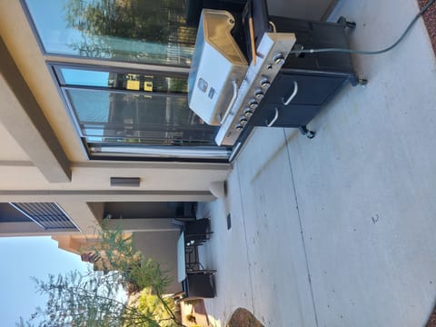 The back patio has a BBQ Grill and seating area.