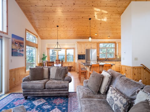 Living/Dining Area, Breakfast Bar (Upper Level) - Enjoy the open airy and light floor plan that extends into the dining area and kitchen from the living room. Showcasing breakfast bar w/seating for 4 and a large french door stainless steel refrigerator with bottom freezer.