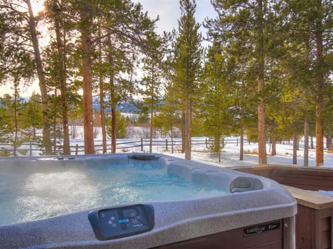 Soak in the private hot tub after a day of fun adventures!