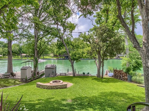 Back yard with fire pit and canoe! Lake level is great!