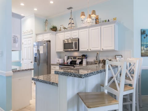 The kitchen bar countertop offers additional seating for guests