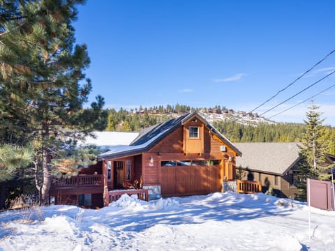 Charming street view of the home with ample parking, a cozy front covered porch, and stunning Tahoe vistas in the backdrop.