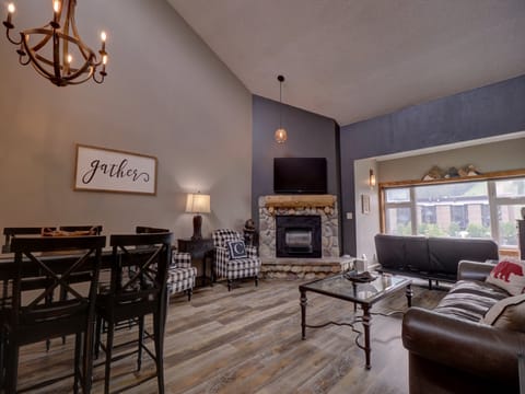 Large living room with tall ceilings and windows allowing ample natural light to come in.