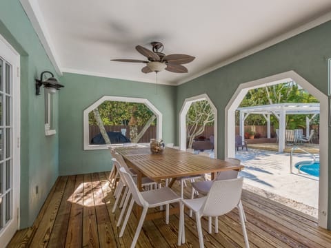 Covered poolside dining table for 12 makes meals together easy