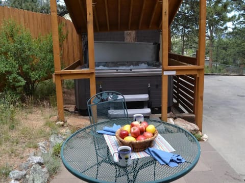 Patio table seating for 2, near the hot tub.