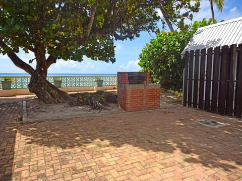 The open outdoor area with a grill and ocean views