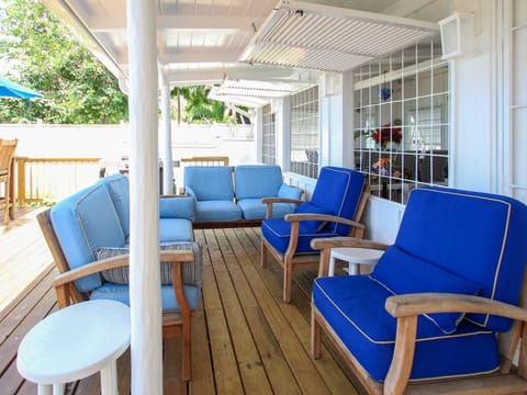 Shaded lounge area on the patio with comfy loungers