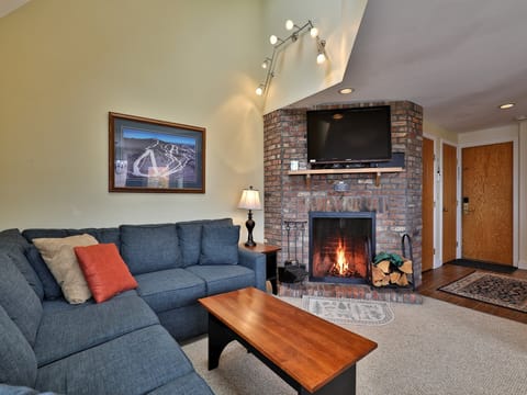 Cozy living room area and wood burning fireplace.