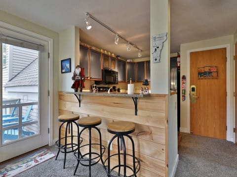 Bar area looking into fully equipped kitchen