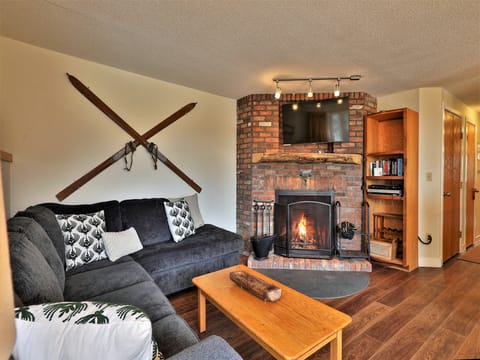 Cozy living room area and wood burning fireplace.