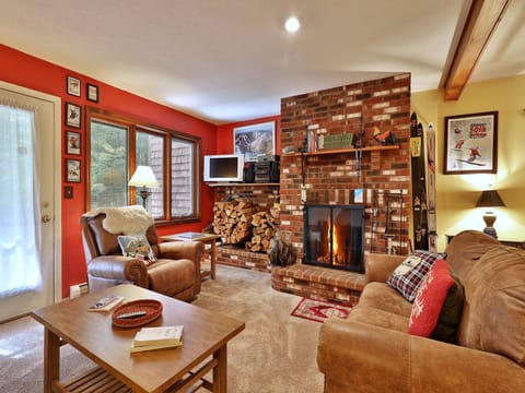 Relax next to the wood burning fireplace in the cozy living room