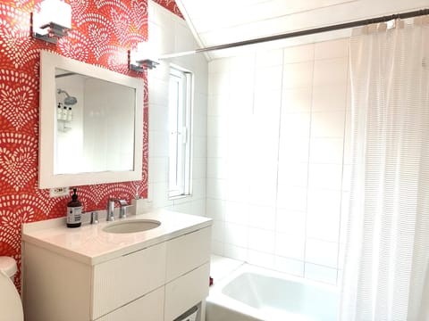 Newly remodeled top floor full bath with shower-tub combination.