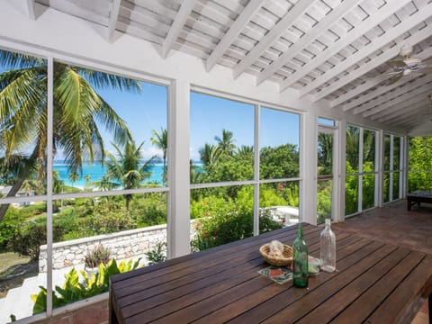 Allamanda's spectacular screen porch, which runs the full length of the house and enjoys sweeping ocean views, ocean breezes, and the sound of the waves.