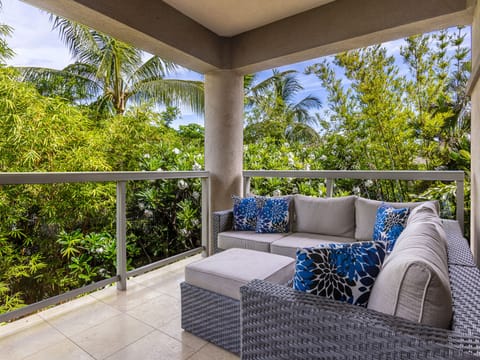 Oversized lanai surrounded by lush tropical foliage