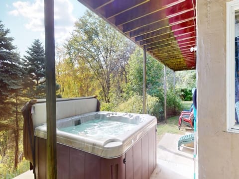 The hot tub is located just outside the lower-level side door.