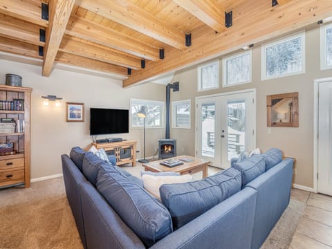 The living area of Viking Lodge 100 opens to a large, riverfront deck with gorgeous mountain views.