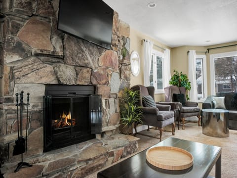 Warm up aside the wood burning fireplace in the living room with beautiful flagstone hearth