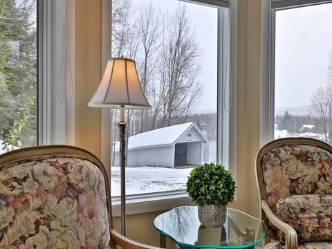 Welcome to the European Room at The Birch Ridge, featuring a king bed, ensuite bathroom, smart TV, gas fireplace and seating with mountain views.