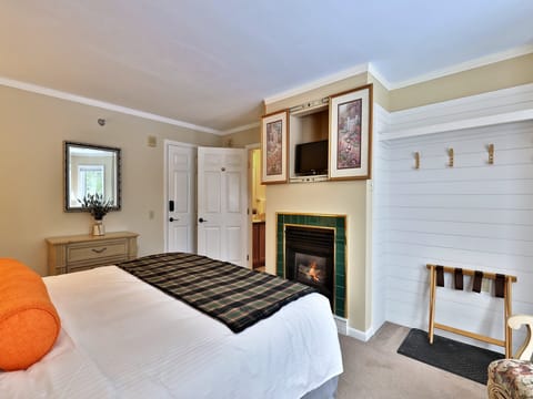 Welcome to the European Room at The Birch Ridge, featuring a king bed, ensuite bathroom, smart TV, gas fireplace and seating with mountain views.