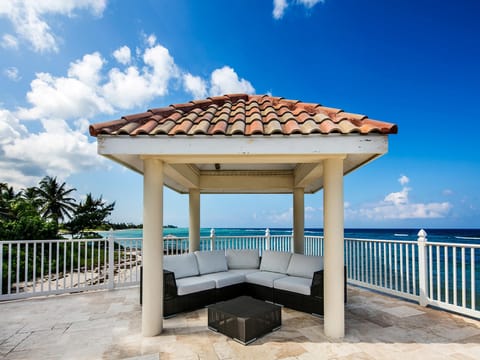 Relax in the outdoor sectional and listen to the waves roll over the shore.