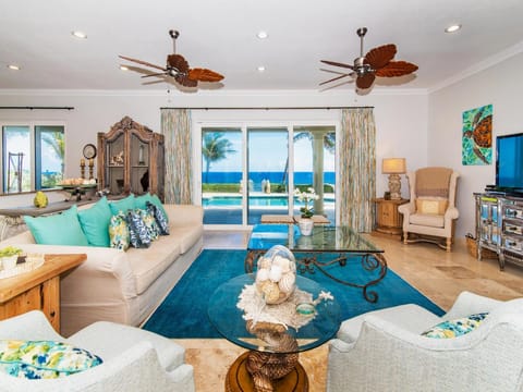Bright and colorful living room with turquoise sea views.