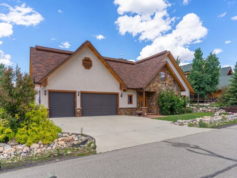 Cherry Drive, your home away from home in beautiful Steamboat Springs! - Large home, driveway, green lawn, blue sky.