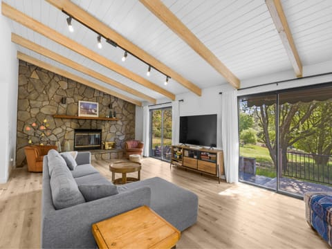 Spacious living room with vaulted open-beam ceiling. Pine Mountain Lake Vacation Rental "The Red House" - Unit 5 Lot 184-A.