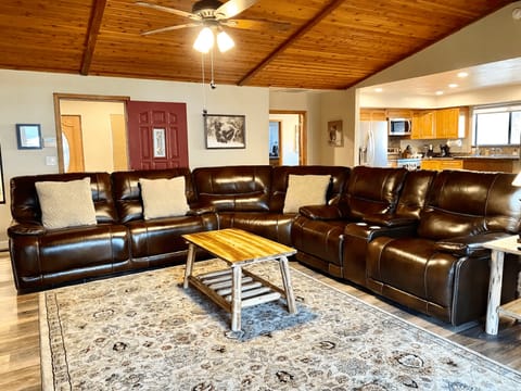 Updated photo of living room with new leather reclining couches.