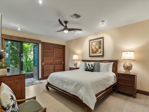 Primary bedroom features a king bed and entrance to the lanai.