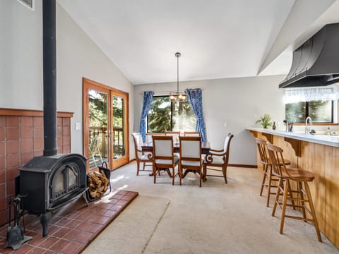 An inviting living room welcomes you, complete with wood burning fireplace, and seating for 6 around the dining table.