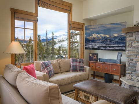 Cozy Living Room with fireplace and panoramic mountain views.