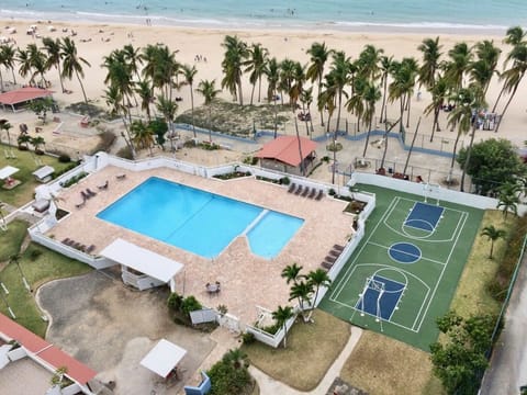 View from the unit shows Common areas for guest to use. Pool- Basketball & play yard. Plus the Beach as backyard.

** Please check COVID GUIDELINES for common area access